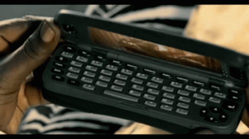 Person Holding Black Cell Phone With Keyboard