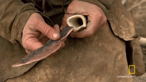 Person Holding Bone and Knife