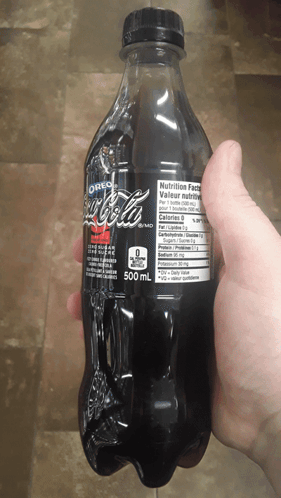 Person Holding Bottle Of Oreo Flavored Coke GIF