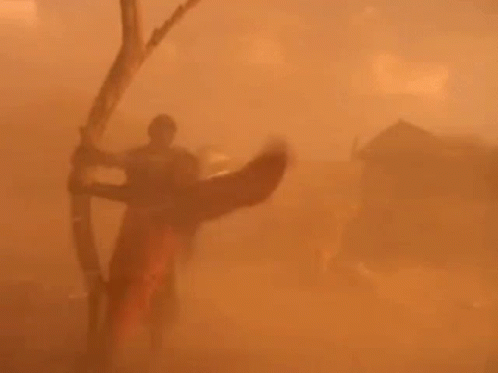Person Holding Bow And Arrow In Desert GIF