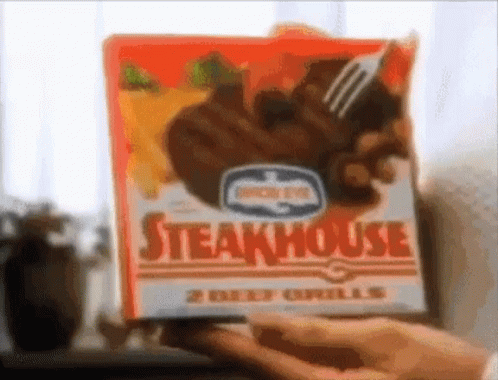 Person Holding Box of Steakhouse Beef Grills With Fork