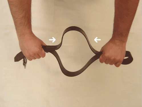 Person Holding Brown Belt With Arrows GIF
