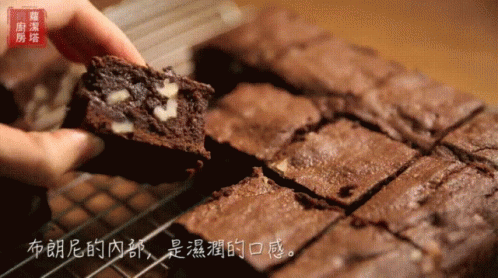 Person Holding Brownie with Chinese Writing