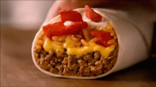 Person Holding Burrito With Cheese, Meat, Rice, Tomatoes