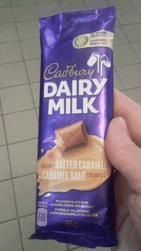 Person Holding Cadbury Dairy Milk Bar GIF