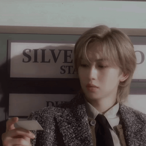 Person Holding Card Near Sign Saying Silve