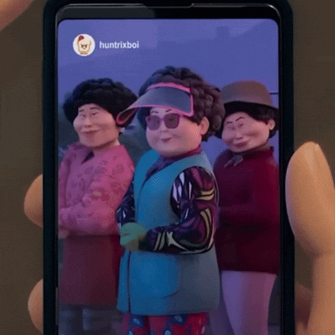 Person Holding Cell Phone With Cartoon Characters