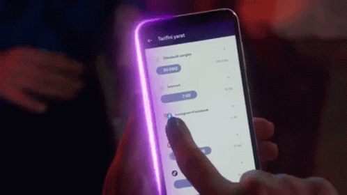 Person Holding Cellphone With Purple Light