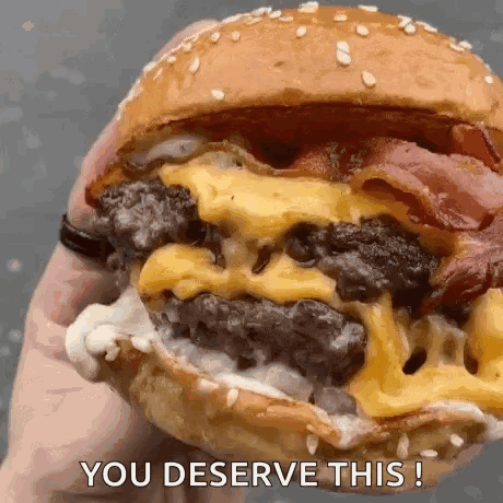 Person Holding Cheeseburger Saying You Deserve This GIF