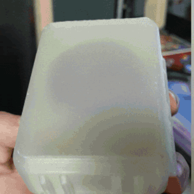Person Holding Clear Plastic Container With White Lid