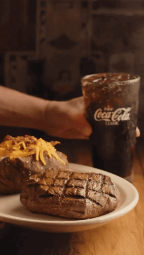 Person Holding Coca-Cola Next To Plate Of Food GIF