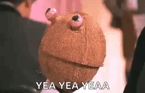 Person Holding Coconut With Eyes GIF