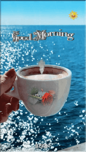Person Holding Coffee In Front Of Ocean GIF