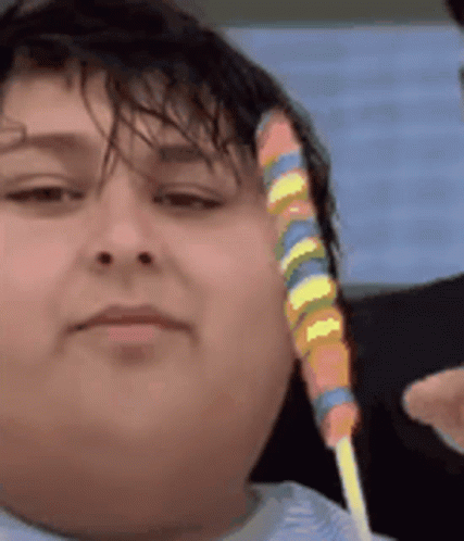 Person Holding Colorful Lollipop GIF