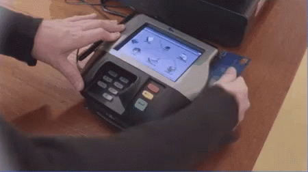 Person Holding Credit Card to Swipe Machine