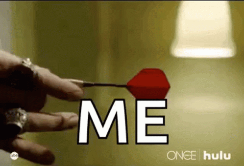 Person Holding Dart Saying Me