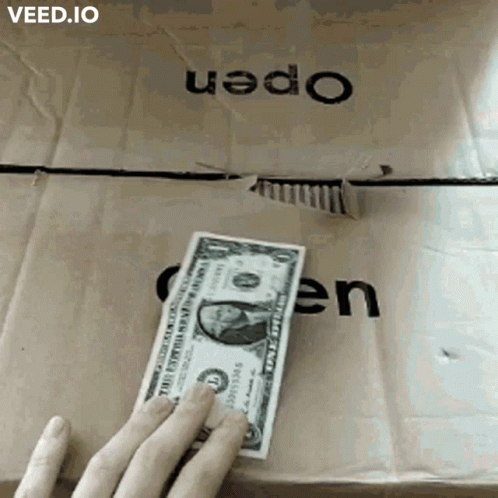 Person Holding Dollar Bill by Box Saying Open