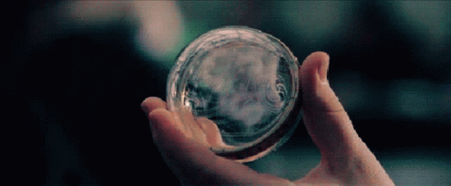Person Holding Glass Ball With Smoke GIF