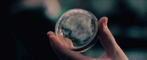Person Holding Glass Sphere GIF