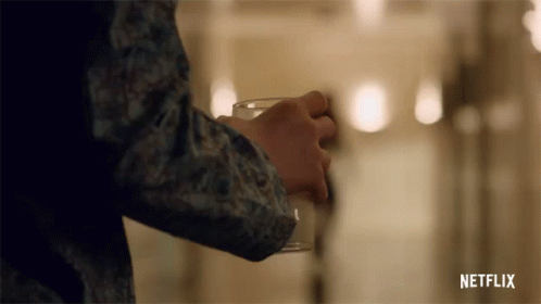 Person Holding Glass With Netflix