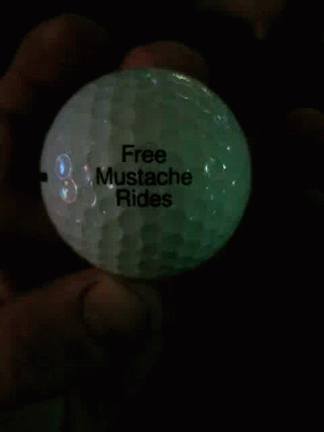 Person Holding Golf Ball with Black Line