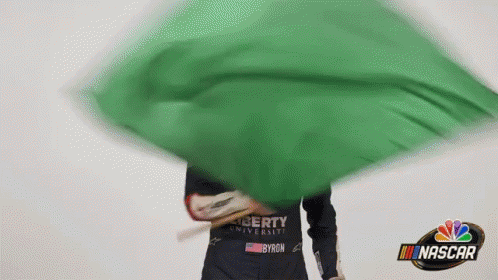 Person Holding Green Flag Saying NASCAR