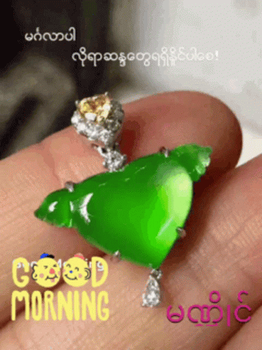 Person Holding Green Pendant Saying Good Morning