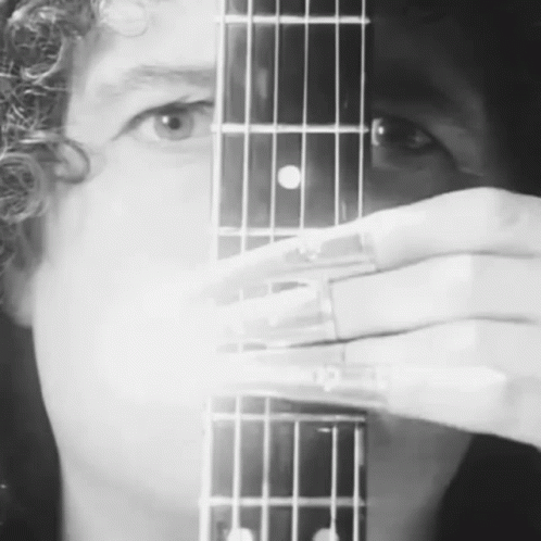 Person Holding Guitar in Black and White