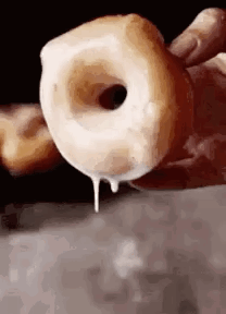 Person Holding Iced Donut