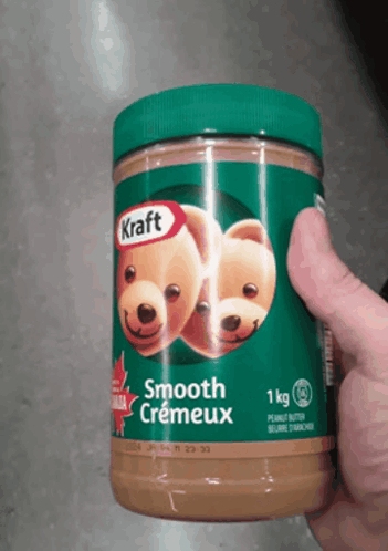 Person Holding Jar of Smooth Creameux Peanut Butter