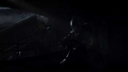 Person Holding Kastov782 Voltspire Rifle in Dark Room