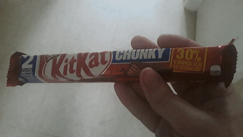 Person Holding KitKat Chunky Candy Bar