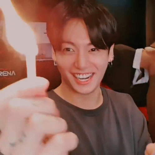 Person Holding Lit Candle Close Up