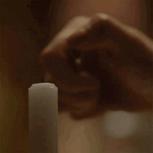 Person Holding Lit Candle