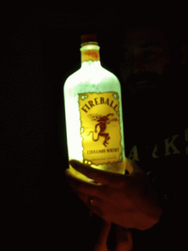 Person Holding Lit Fireball Whiskey