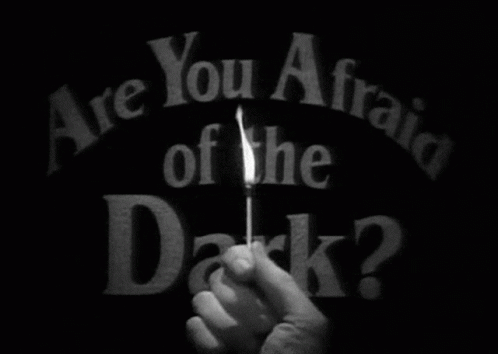 Person Holding Lit Match Saying Are You Afraid of the Dark