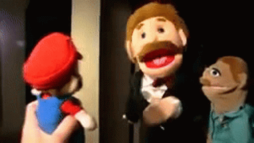 Person Holding Mario Puppet With Two Others Watching GIF