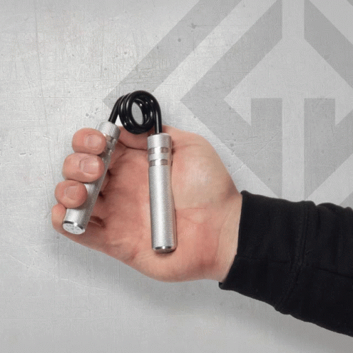 Person Holding Metal Hand Gripper With Black Spring