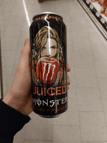 Person Holding Monster Juice Can