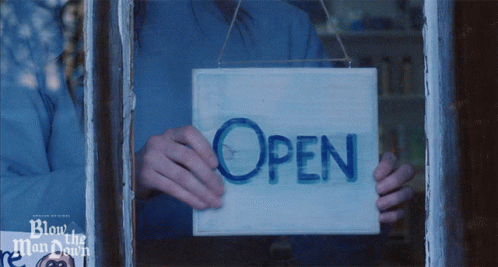 Person Holding Open Sign