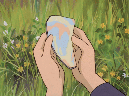 Person Holding Paper in Flower Field