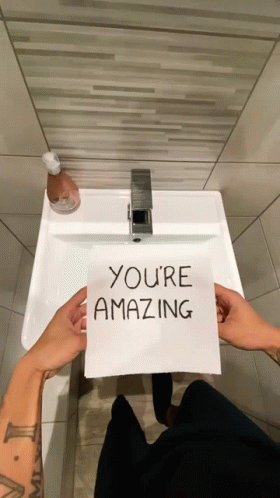 Person Holding Paper Saying You're Amazing