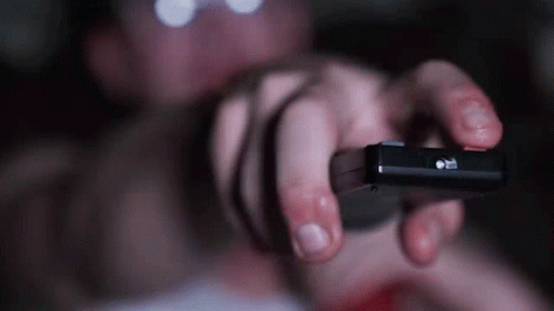 Person Holding Pause Button Remote