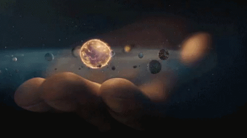 Person Holding Planet Surrounded By Planets