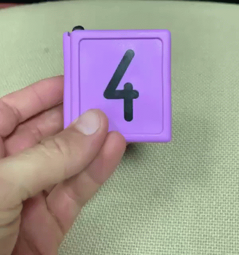 Person Holding Purple Item With Number Four GIF