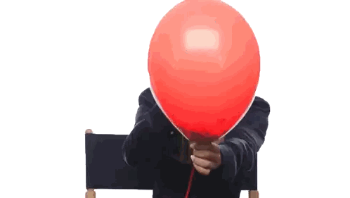 Person Holding Red Balloon