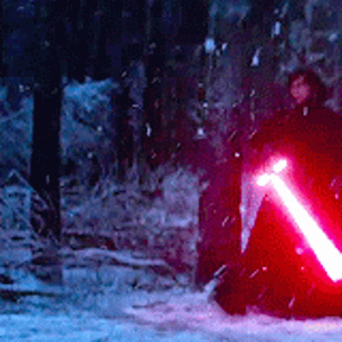 Person Holding Red Lightsaber in Snow