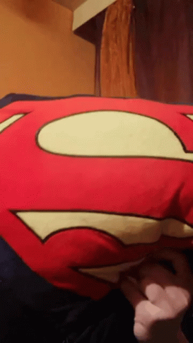 Person Holding Red Superman Pillow GIF