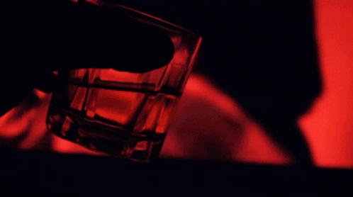 Person Holding Shot Glass With Red Light