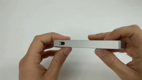 Person Holding Silver Object with Small Hole